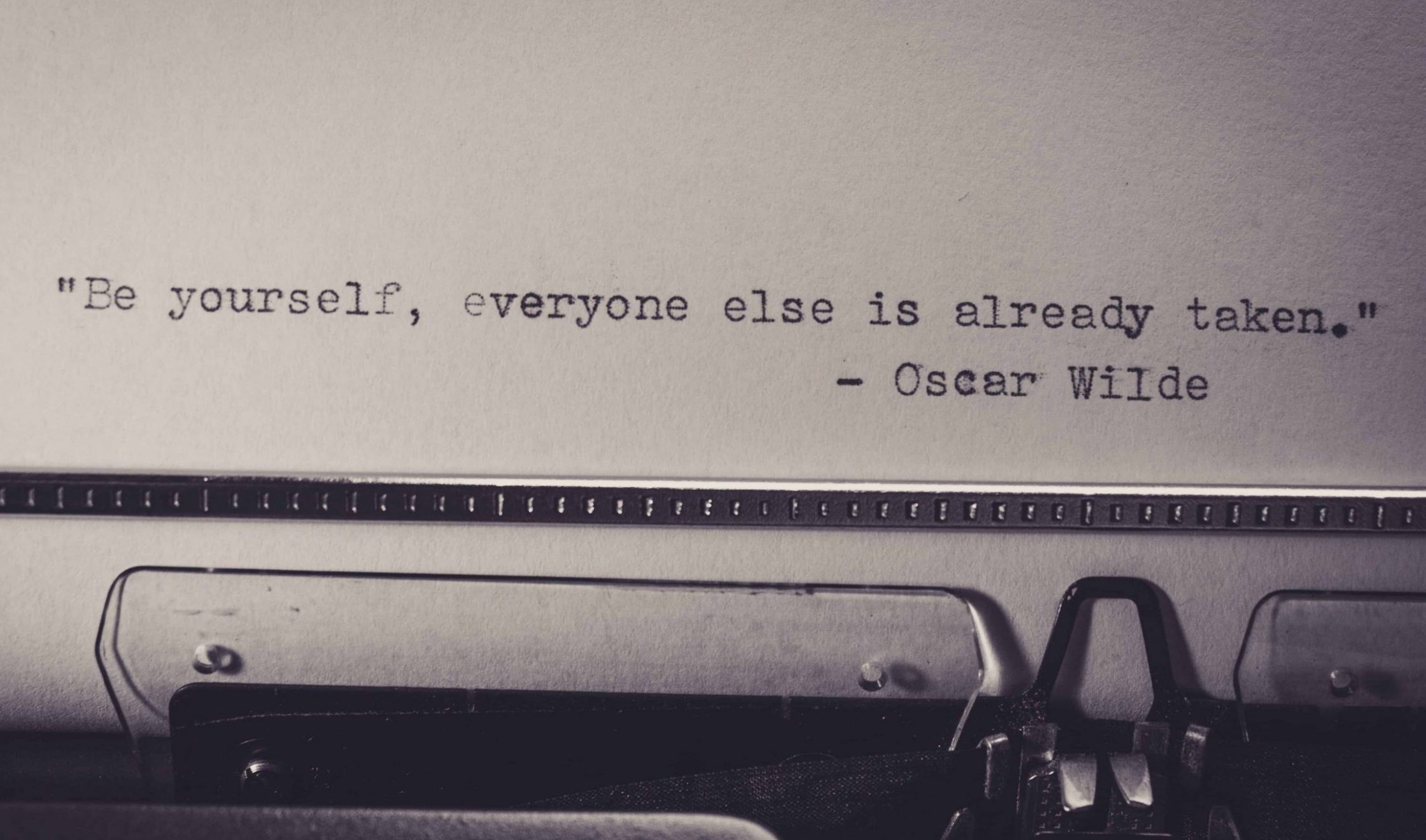 "Be yourself, everyone else is already taken." Oscar Wilde quote typed on a typewriter