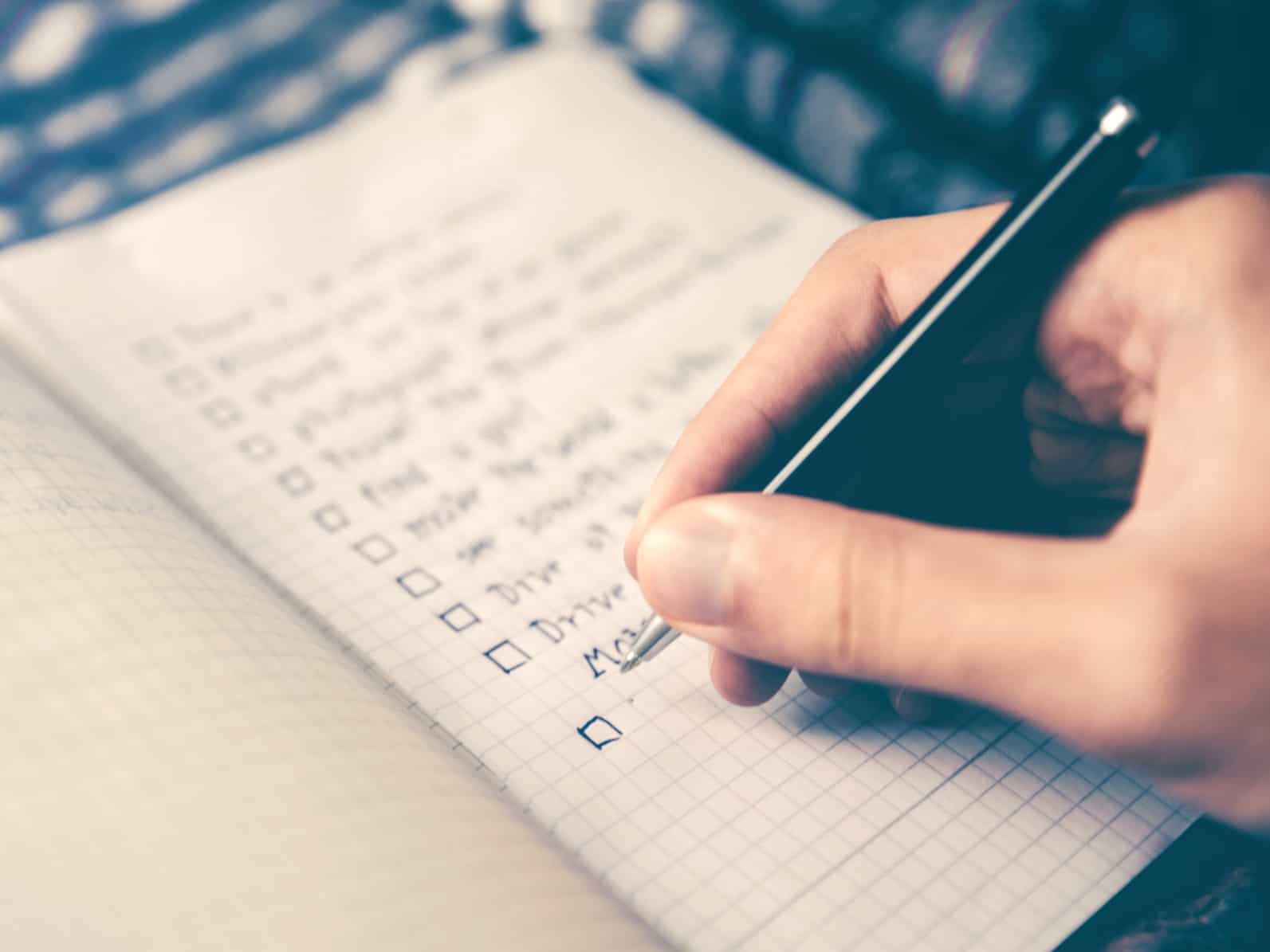 A person writing a to-do bucket list