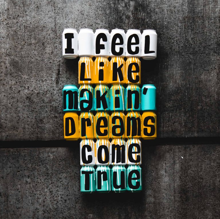 "I feel like makin' dreams come true" quote painted on different colored cans
