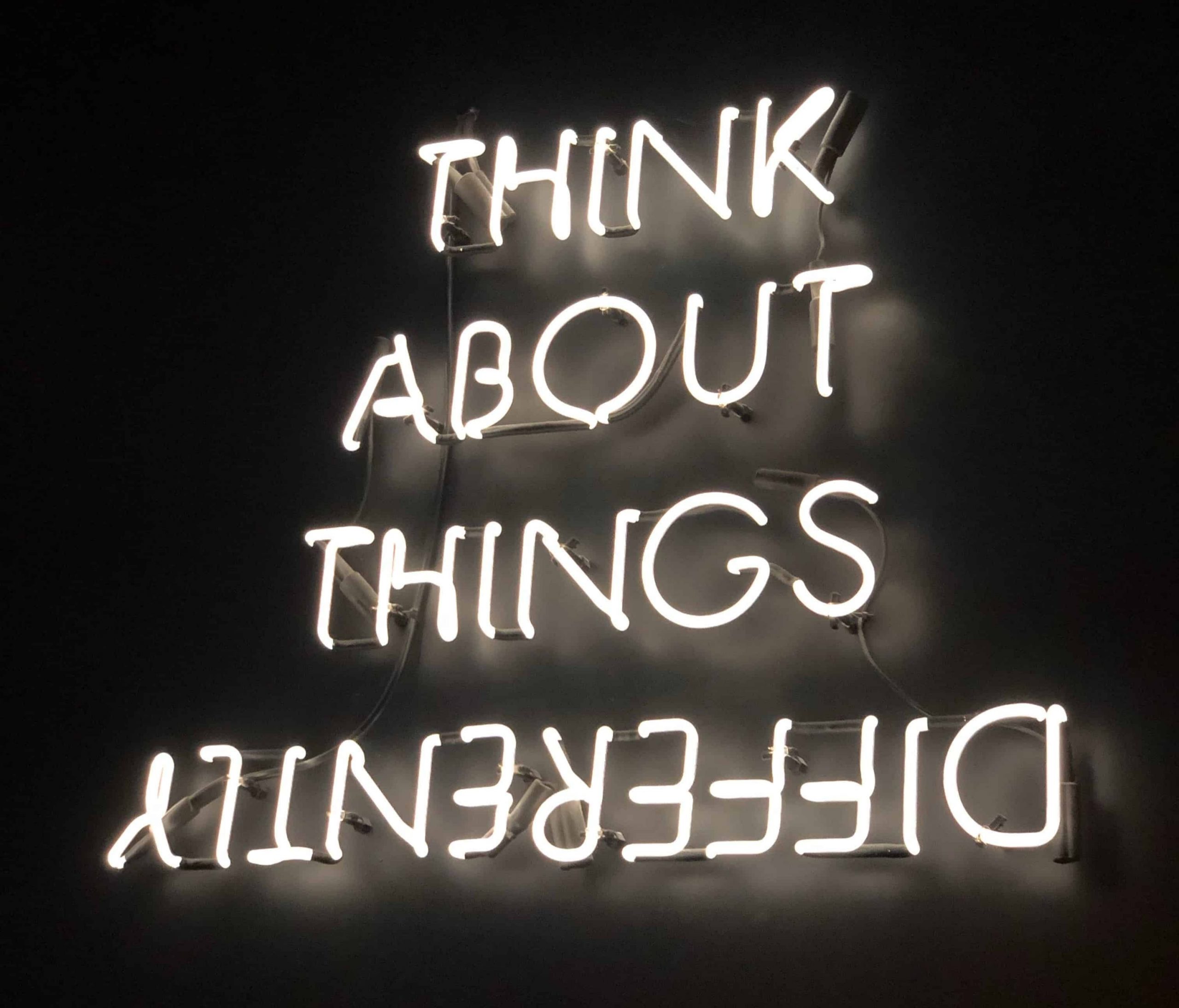 "Think about things differently" quote made of fluorescent lights