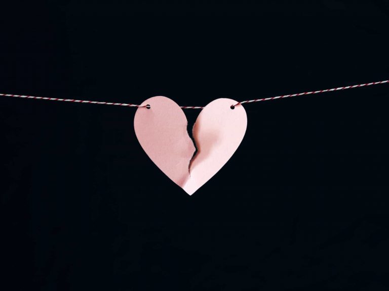 A paper heart on a string that's ripping in half