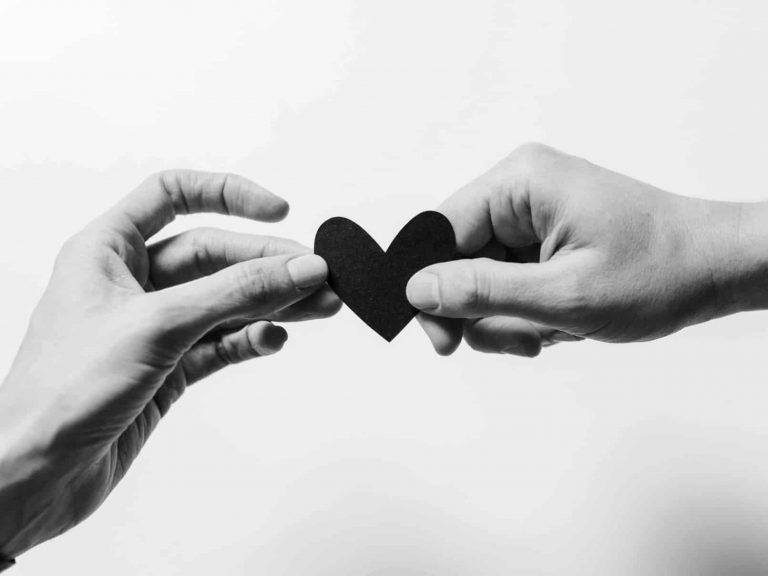 Two hands holding a whole heart