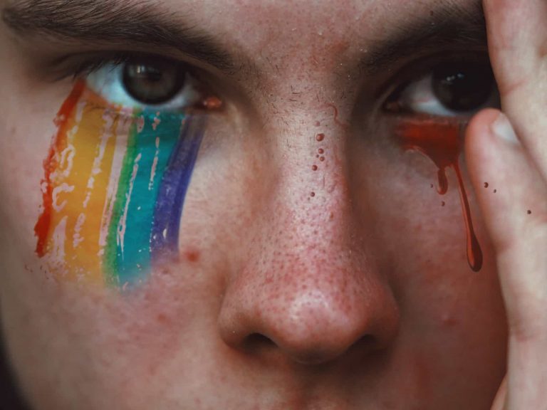 Close up of a person crying colorful, rainbow tears