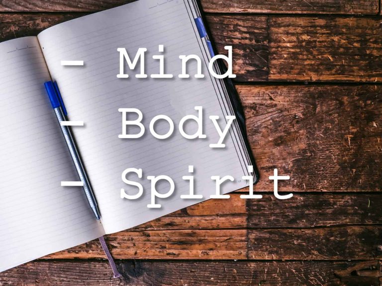 A list with Mind, Body, and Spirit on a notebook