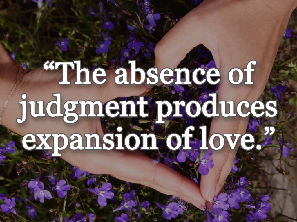 “The absence of judgment produces expansion of love.” quote over picture of a person making a hand heart with flowers blooming below