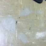 Grey ghost shoe prints on a tile floor