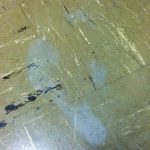 Grey ghost shoe prints on a tile floor