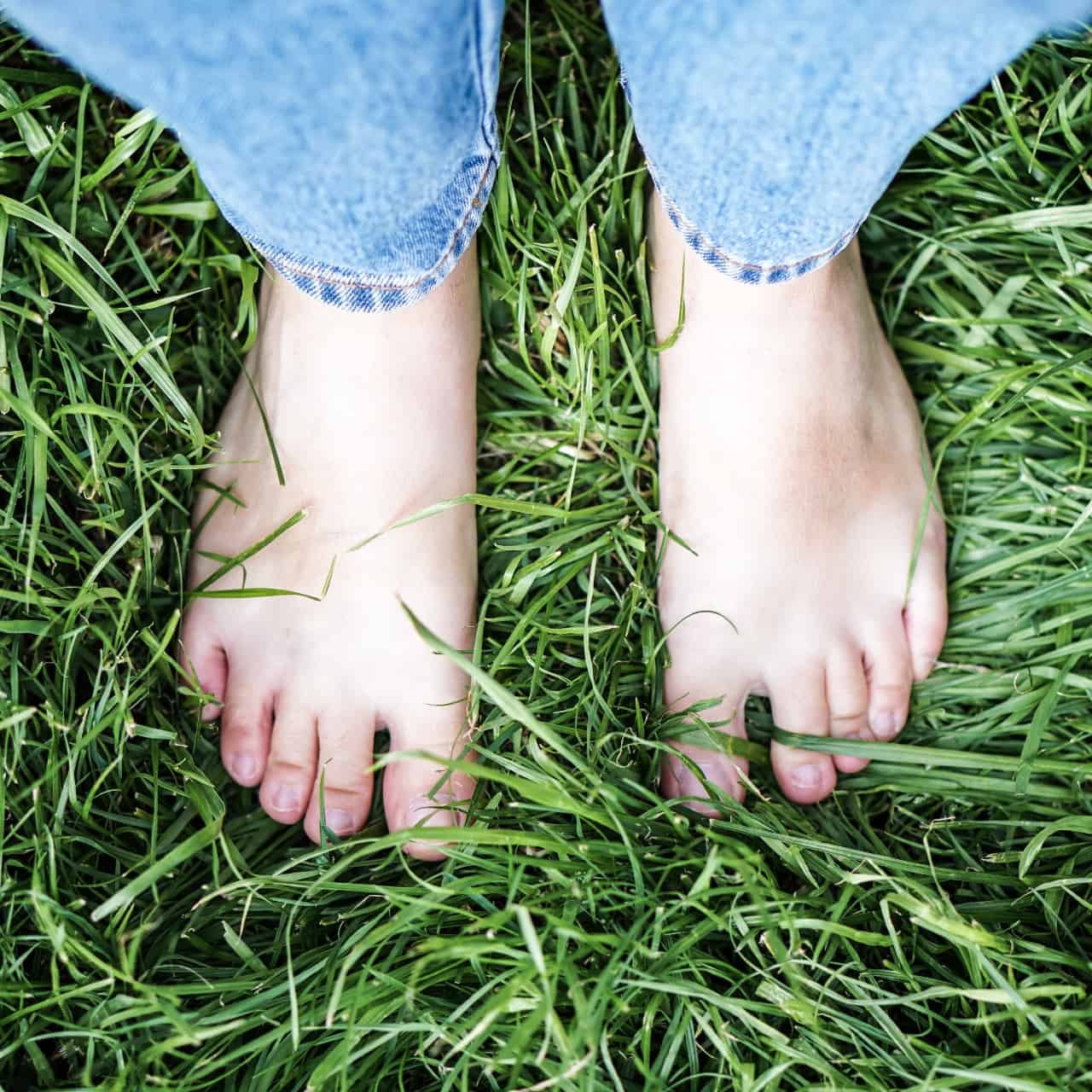 Person's bare feet on the grass