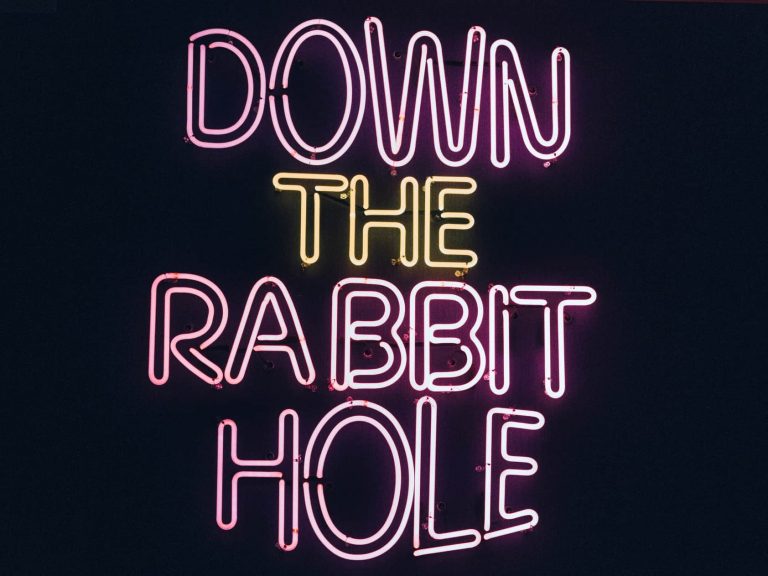 "Down the rabbit hole" neon wall sign
