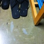 Small and thin grey ghost shoe prints on a tile floor