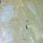 Grey ghost shoe prints on a tile floor