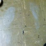 Grey ghost shoe prints on a tile floor