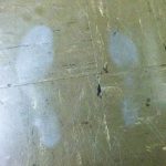 Grey ghost shoe prints on a tile floor