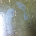 Grey ghost shoe prints on a tile floor