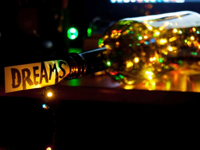 String lights in a bottle with a cork that says, "Dreams"