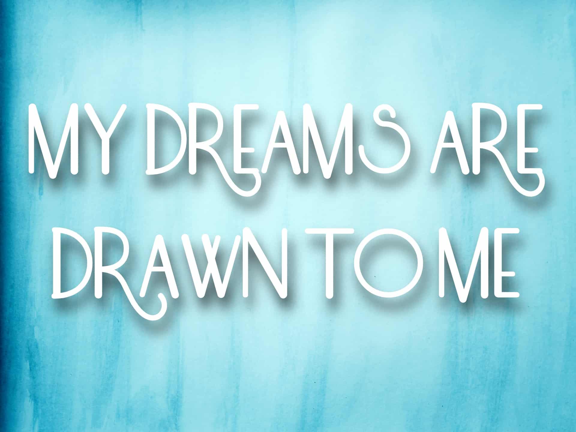 "My dreams are drawn to me" mantra on a blue watercolor background