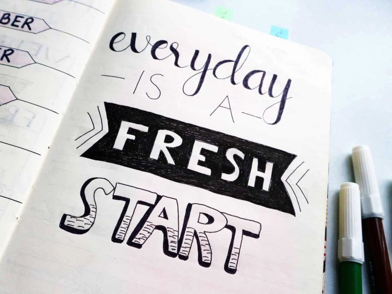 A notebook with the quote, "Everyday is a fresh start"