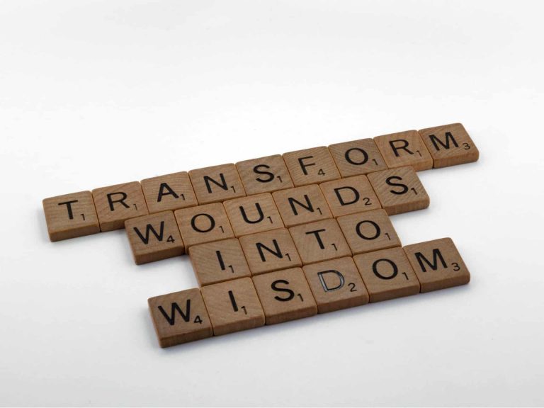 "Transform wounds into wisdom" written in scrabble letters