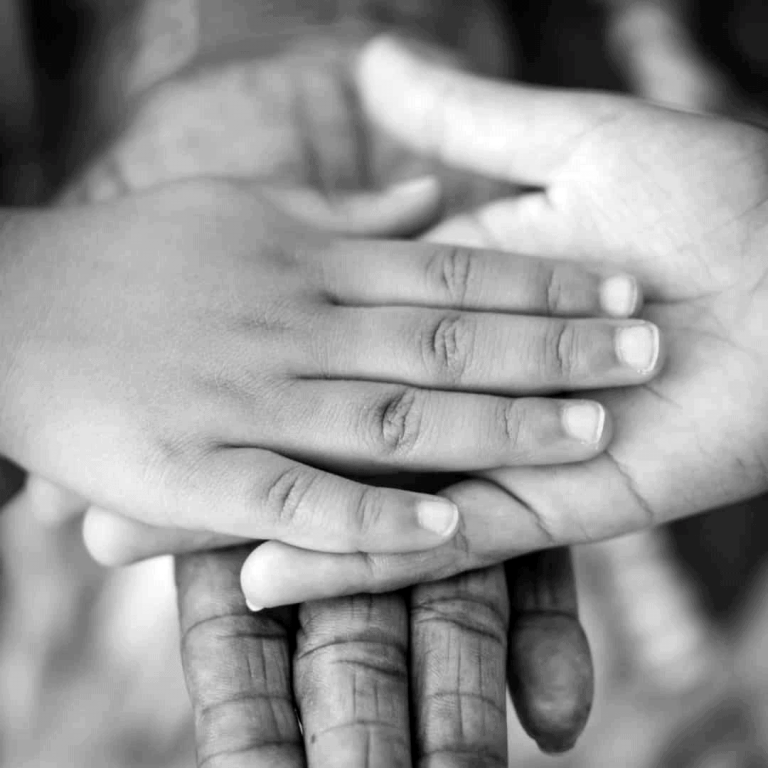 A layering of 3 generations of hands in black and white