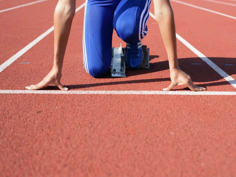 A person at the starting line of a race in go position