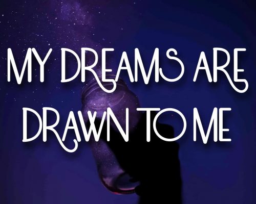 A person holding a jar to the night sky with stars going into it with the mantra, "My dreams are drawn to me"