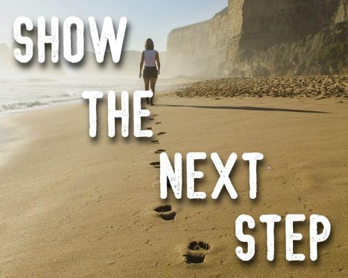 "show the next step" mantra over a picture of a person walking on the beach