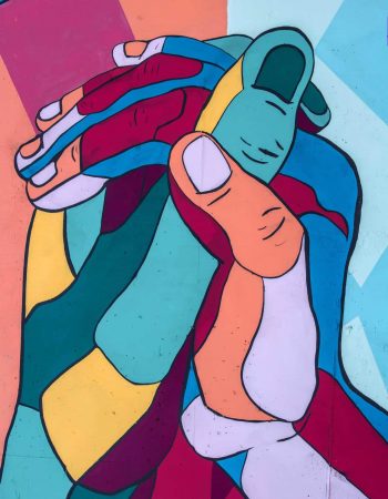 Multicolor hands holding in an embrace